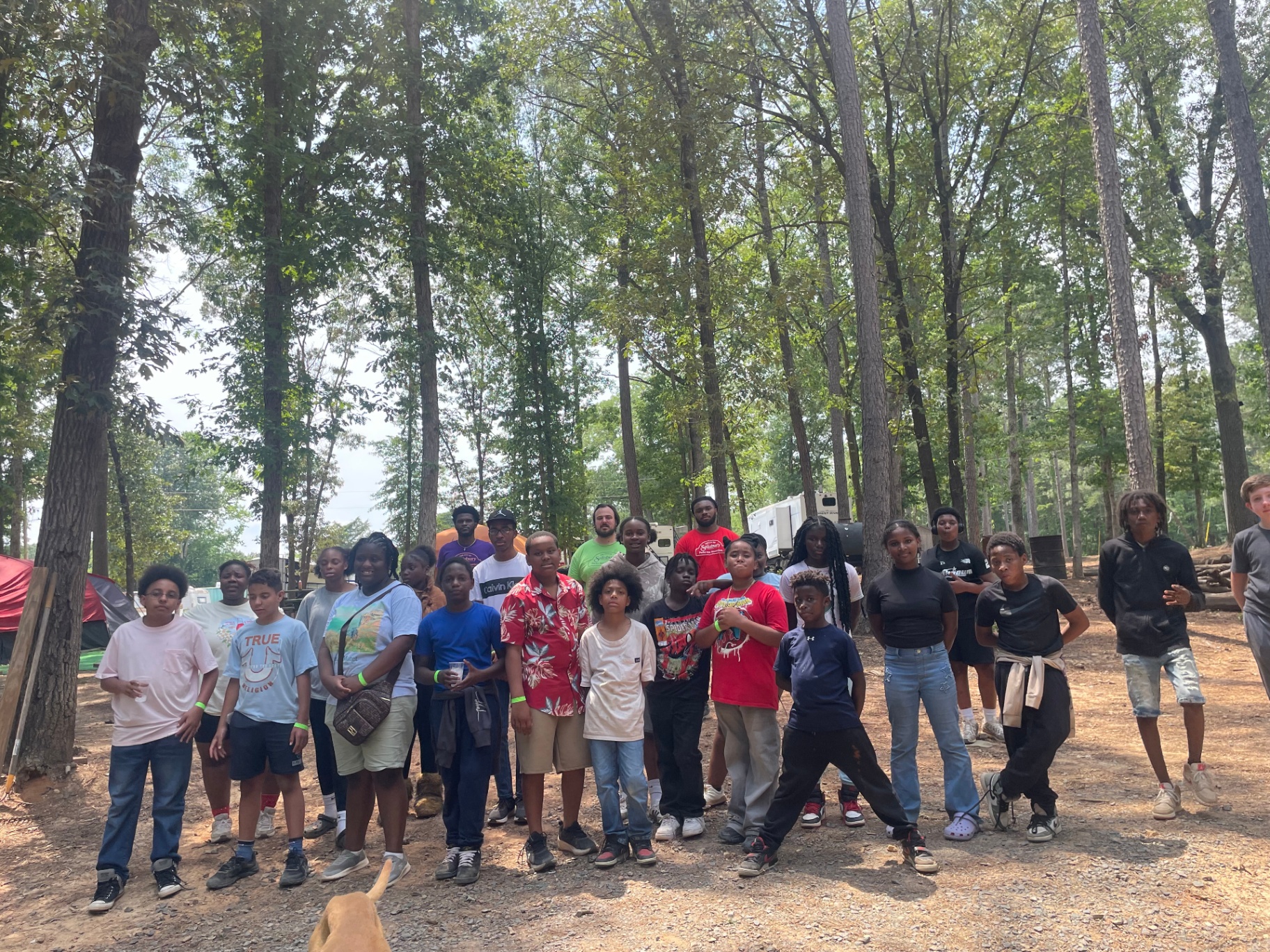 Group of campers gathered in the woods at Cobles Landing